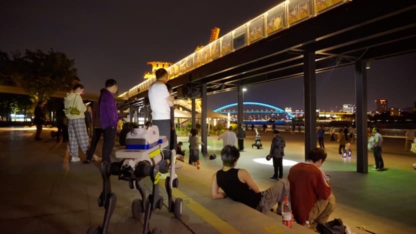 Patrol robot dog operating at night in a public waterfront area